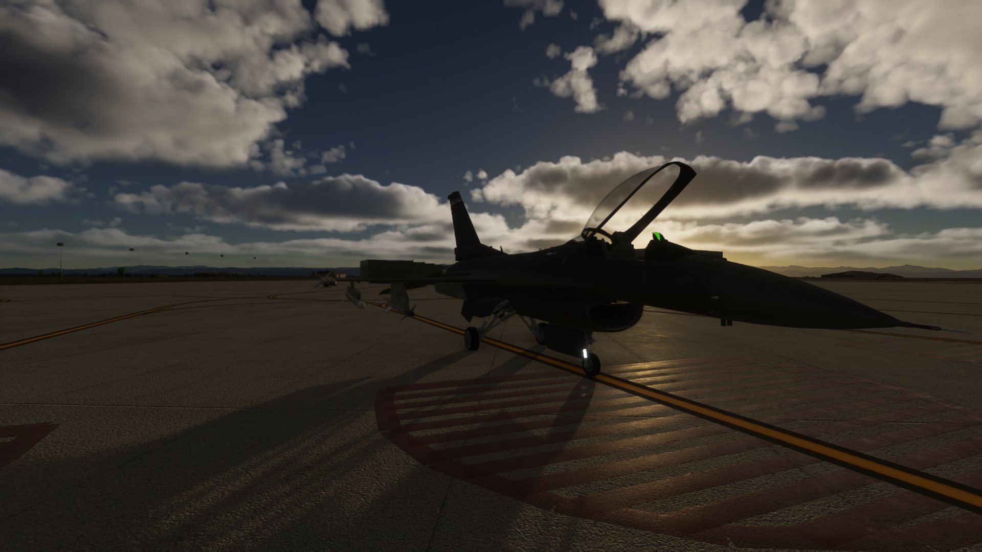 Virtual F-16 aircraft parked on a flight line at sunset